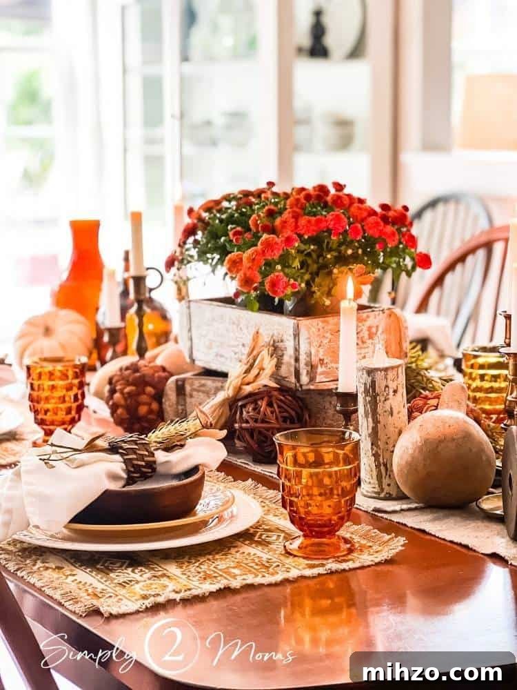 13+ Creative Ways to Make Your Thanksgiving Memorable 4 Vintage autumn table with gold and white place settings, centerpiece with brick molds, mums, dried gourds, brass candlesticks, and amber glass goblets