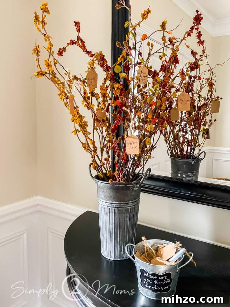13+ Creative Ways to Make Your Thanksgiving Memorable 6 thankful tree in galvanized bucket on black table in front of mirror