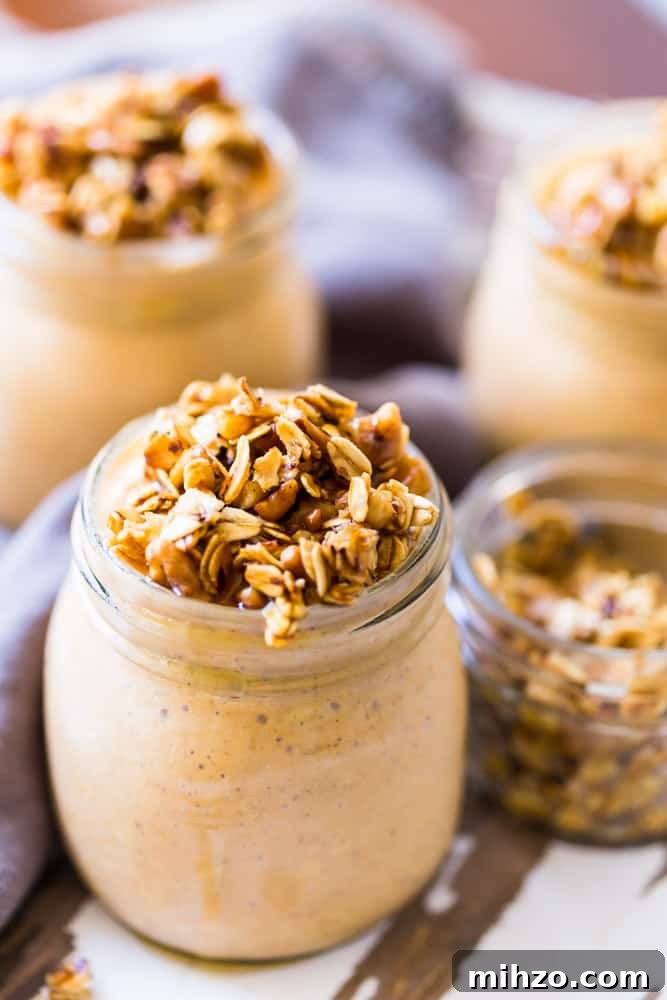 13+ Creative Ways to Make Your Thanksgiving Memorable 9 Overhead view of three Small jars filled with pumpkin cheesecake overnight oats with a maple walnut crumble on top.