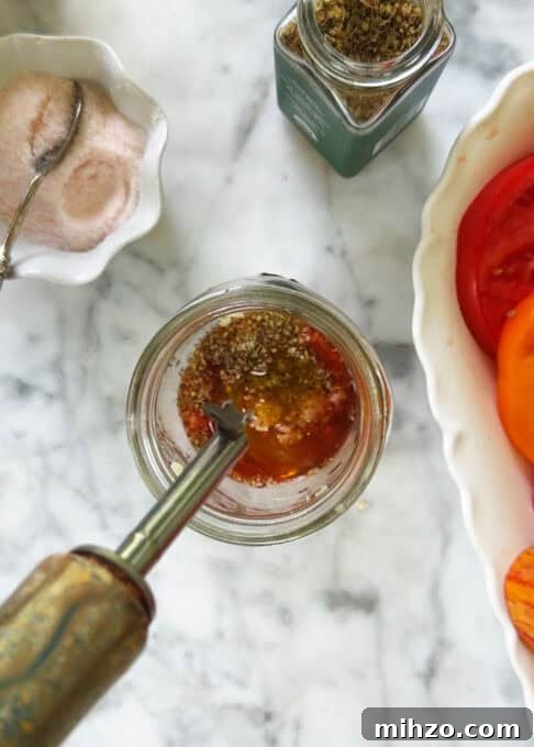 Oregano and red wine vinegar added to the mason jar