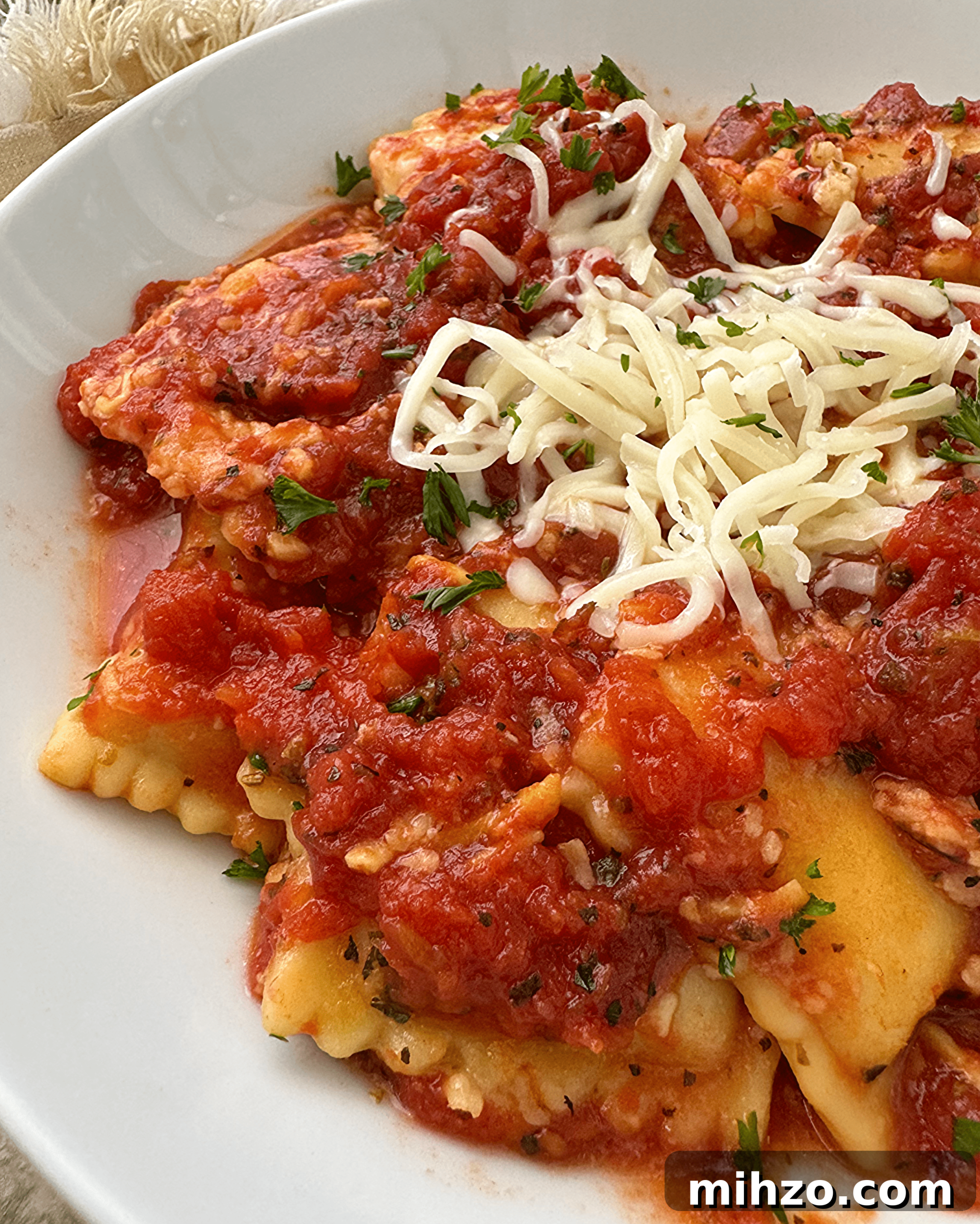 Slow Cooker Cheese Ravioli Casserole (Video Recipe) 2 slow cooker ravioli on a white plate