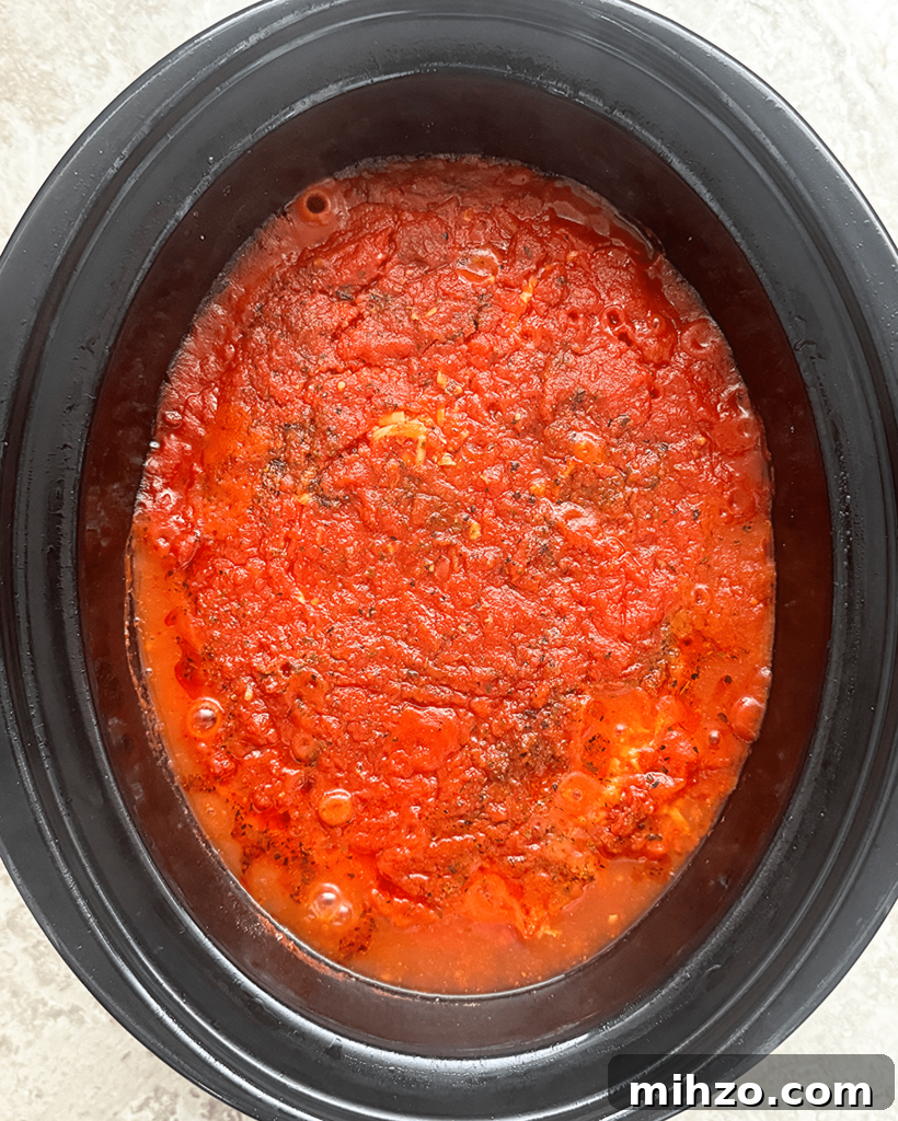overhead shot of cooked ravioli casserole in a black slow cooker