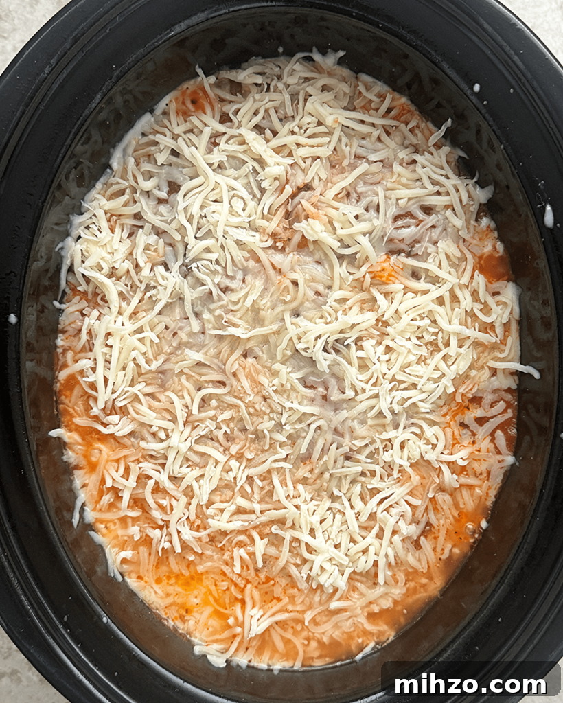 overhead shot of cooked ravioli casserole in a black slow cooker