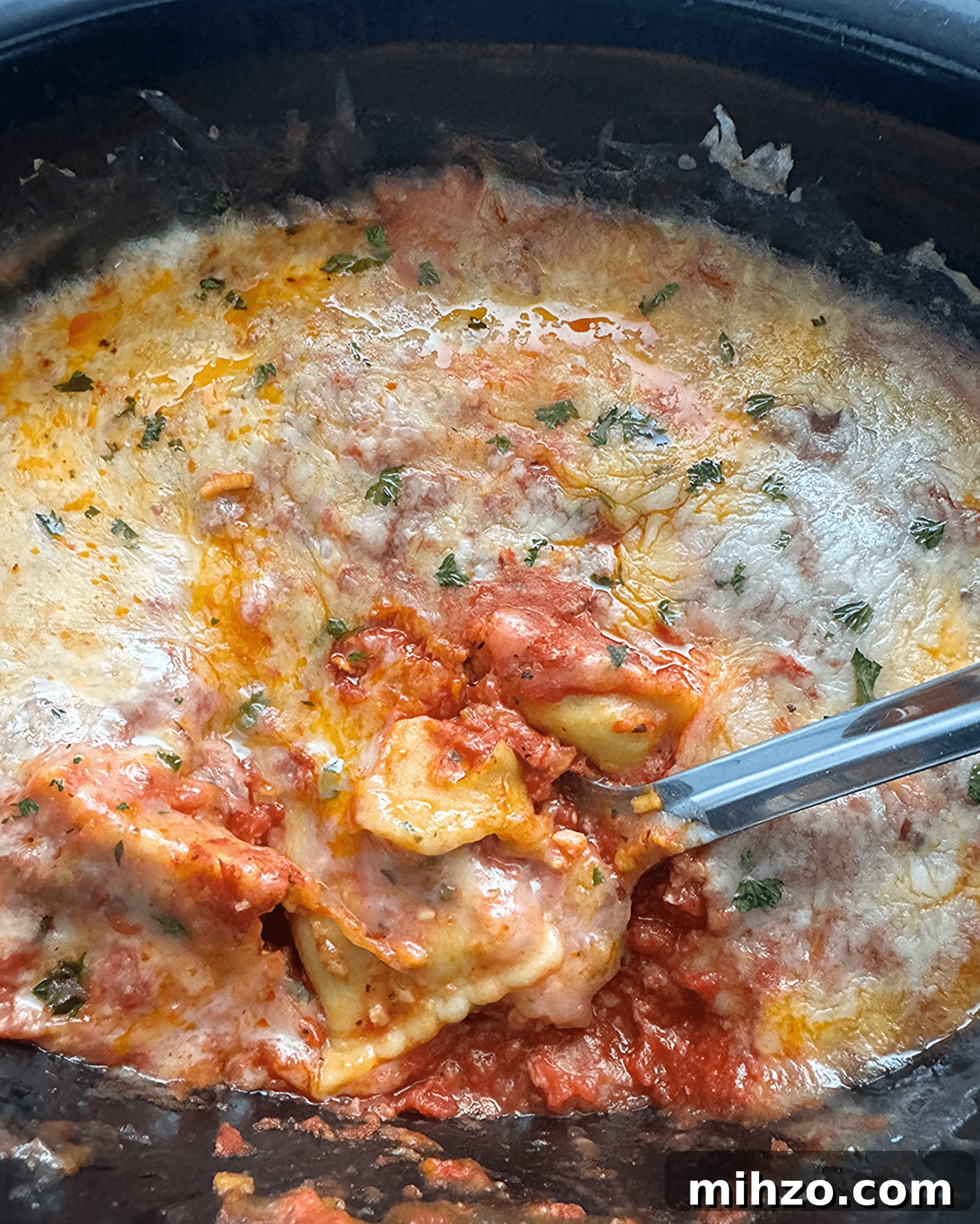 Slow Cooker Cheese Ravioli Casserole (Video Recipe) 8 slow cooker ravioli on a white plate