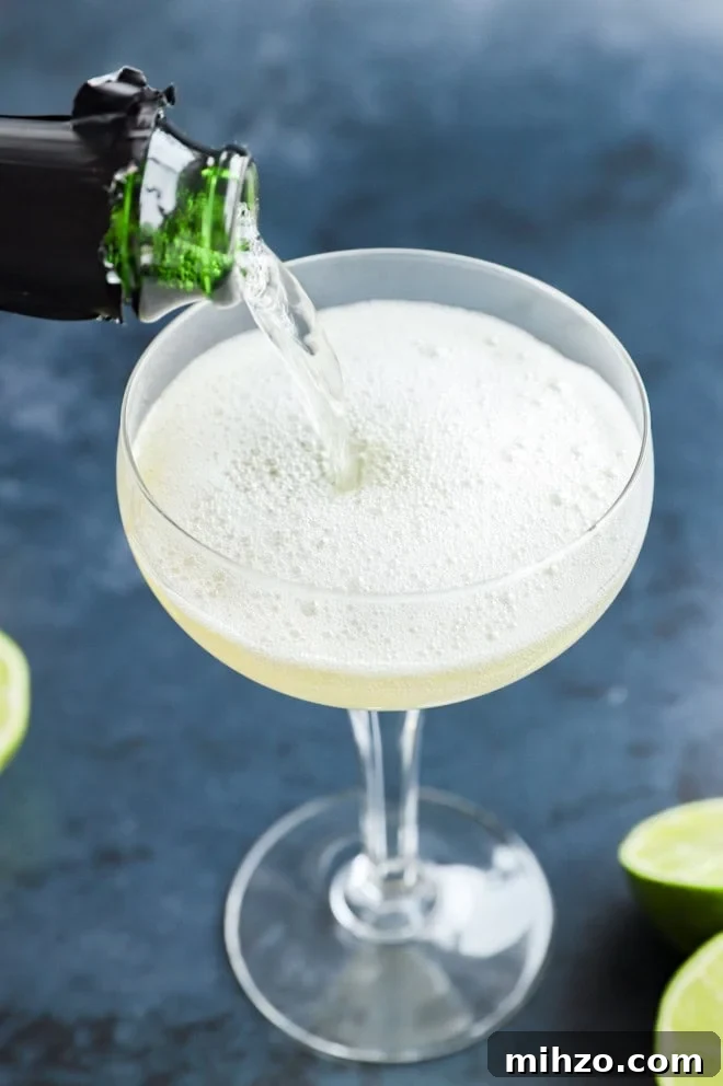 Elderflower Sparkling Cocktail Guide 4 pouring champagne into a coupe glass