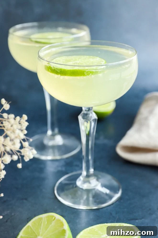 Elderflower Sparkling Cocktail Guide 8 elderflower cocktail in glasses with limes and flowers in the background