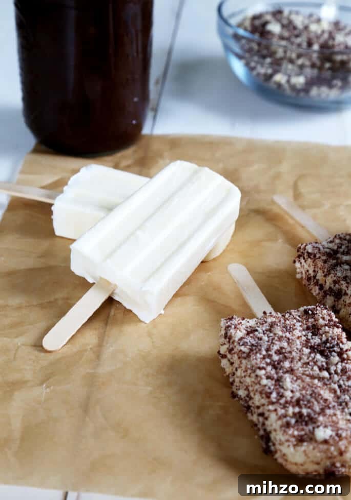 Gluten-Free Chocolate Éclair Ice Cream Bars (Good Humor Copycat) 3 Vanilla ice cream bars and chocolate eclair ice cream bars on beige surface