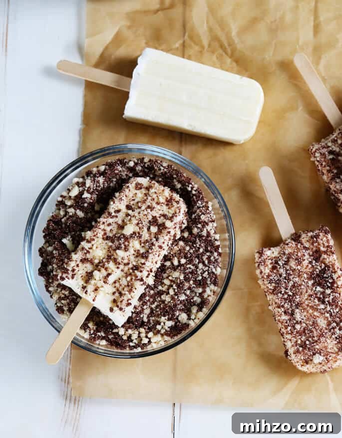 Gluten-Free Chocolate Éclair Ice Cream Bars (Good Humor Copycat) 4 Vanilla ice pops being dipped in chocolate eclair crumbs
