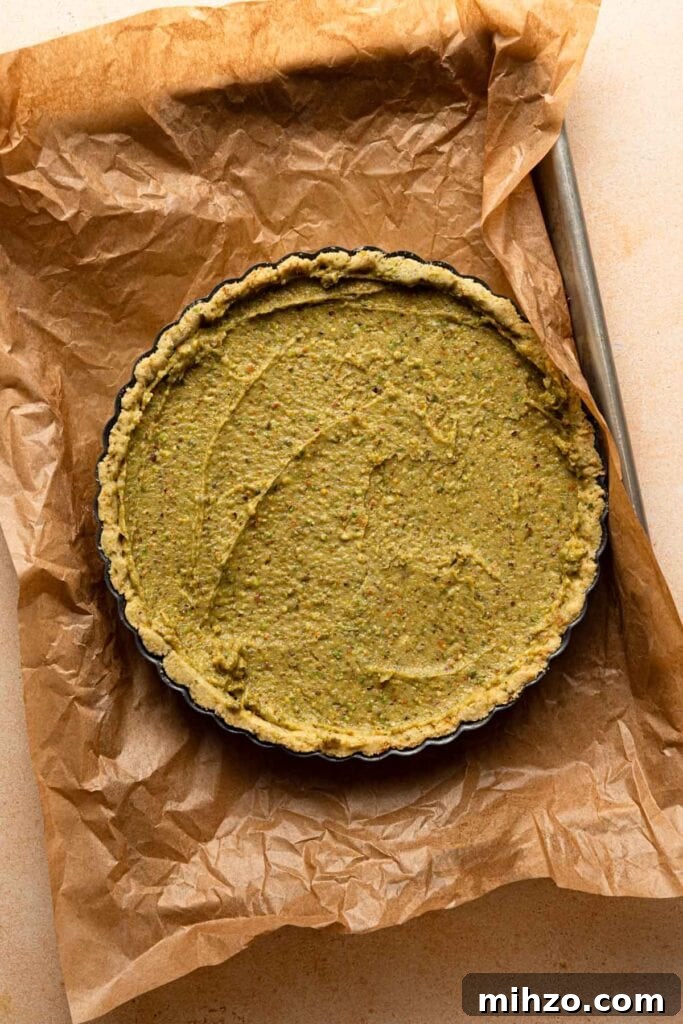 Pistachio Frangipane Tart Recipe — Crunchy Almond-Pistachio Filling 6 Baked tart showing a golden frangipane.