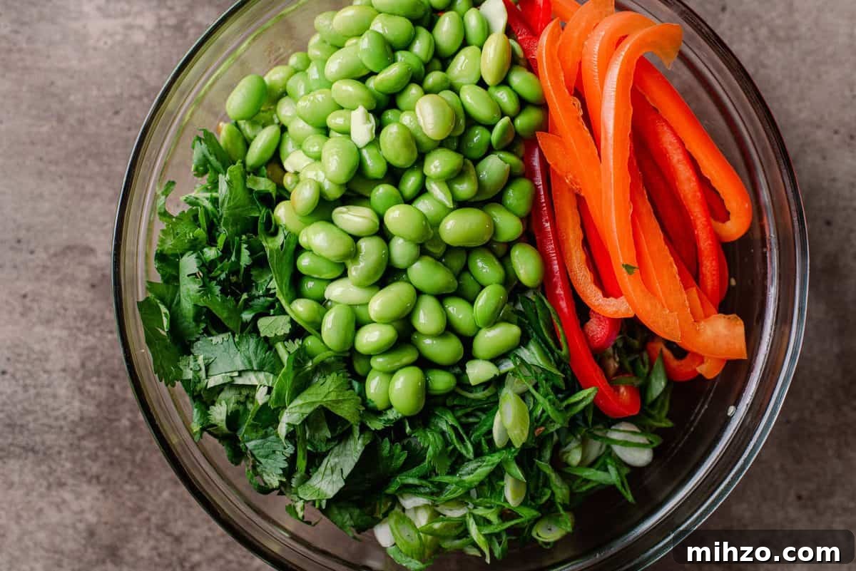 cilantro, edamame, and bell peppers in a glass bowl