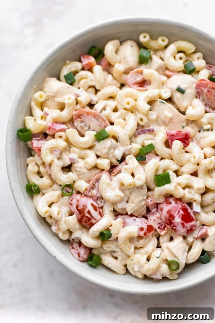 Spicy Cajun Pasta Salad with Creamy Remoulade Dressing 2 close-up of white bowl with Cajun pasta salad made with Tony Chachere's Creole Seasoning