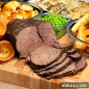 Slow cooker beef joint cut into thin slices. Served amongst honey roast parsnips, yorkshire puddings, peas, cauliflower and broccoli cheese and roast potatoes