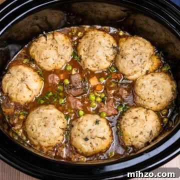 Slow Cooker Beef Stew with eight Dumplings on top