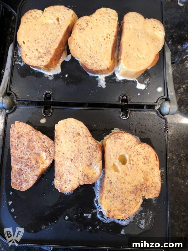 Elvis-Inspired Banana-Peanut Butter Challah French Toast 6 Overhead view of Elvis-Style Challah French Toast cooking on a griddle.
