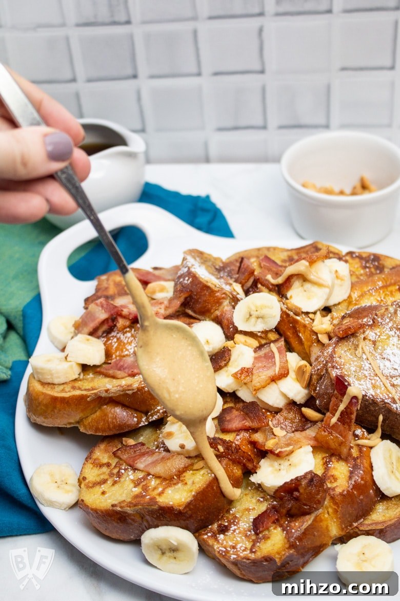Elvis-Inspired Banana-Peanut Butter Challah French Toast 8 Hand drizzling peanut butter onto a platter of Elvis-Style Challah French Toast