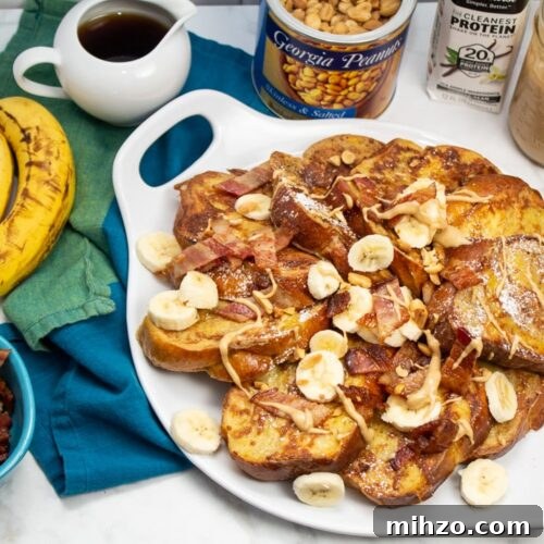 Elvis-Inspired Banana-Peanut Butter Challah French Toast 10 Overhead view of French toast with bananas, bacon, peanut butter, and topping alongside.