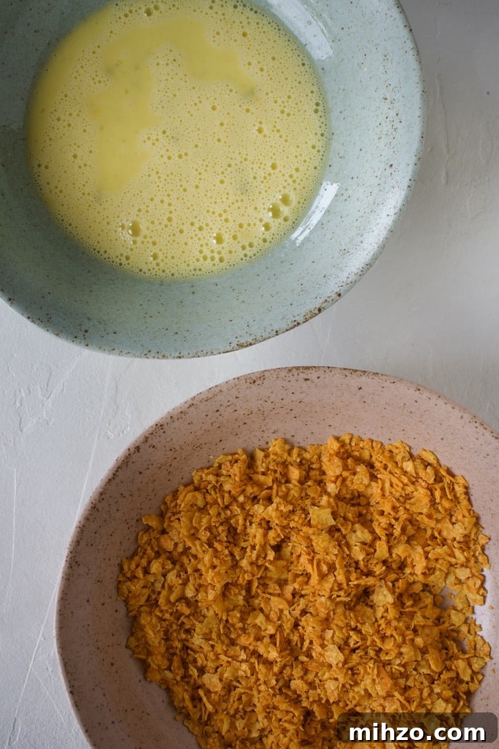 Crunchy Dorito-Crusted Baked Chicken Recipe 4 Dorito Crumbs and Beaten Eggs prepared for breading chicken in them.