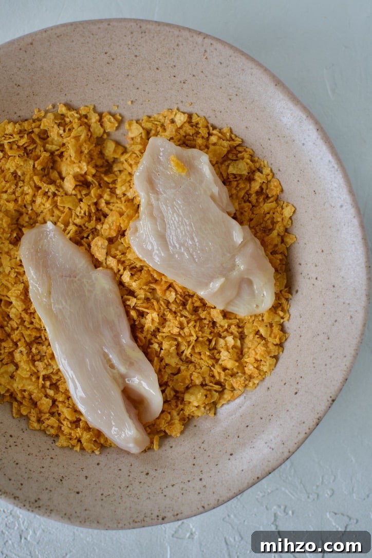 Crunchy Dorito-Crusted Baked Chicken Recipe 6 Rolling chicken tenders in dorito crumbs.