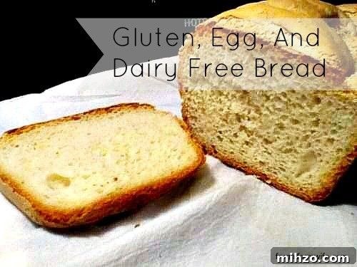 Gluten-Free, Dairy-Free, and Egg-Free Bread Recipe 2 Image shows a loaf of bread on a white napkin with one slice cut off the end. Text overlay reads "Gluten, Egg and Dairy Free Bread"