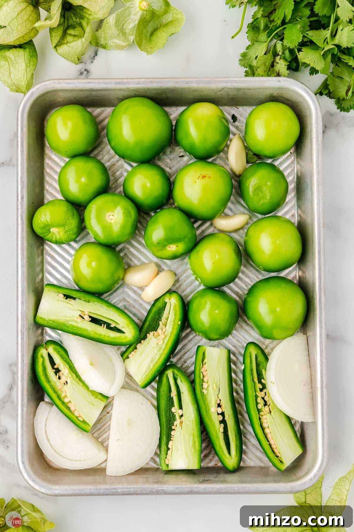 wash tomatillos and place on a rimmed baking sheet with onions and jalapeno peppers