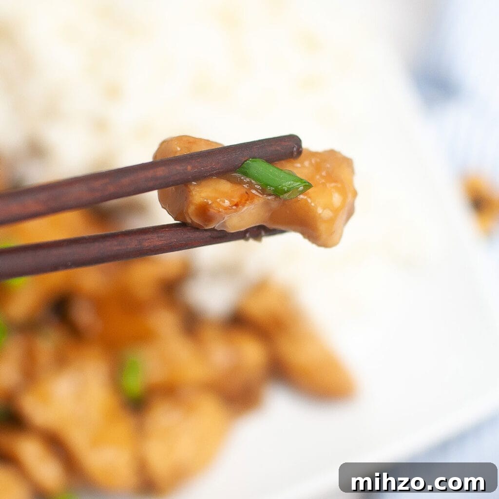 Slow Cooker Teriyaki Chicken Recipe for Tender, Flavorful Meals 9 chopsticks holding piece of Slow Cooker Teriyaki Chicken