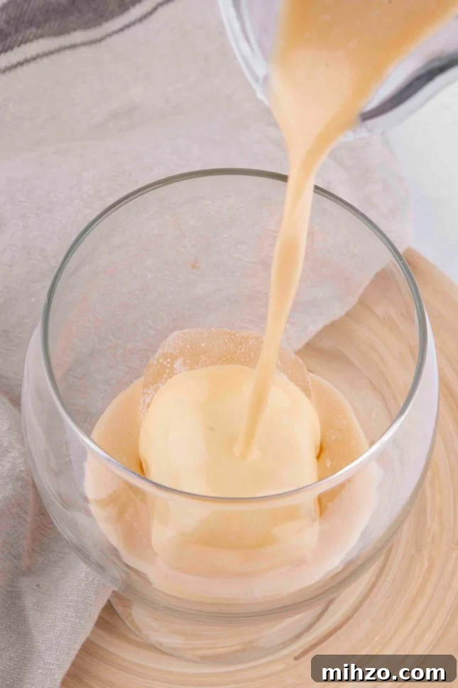 Vegan Baileys Recipe: Homemade Irish Cream Without Dairy 2 Photo of some vegan Baileys being poured into a glass