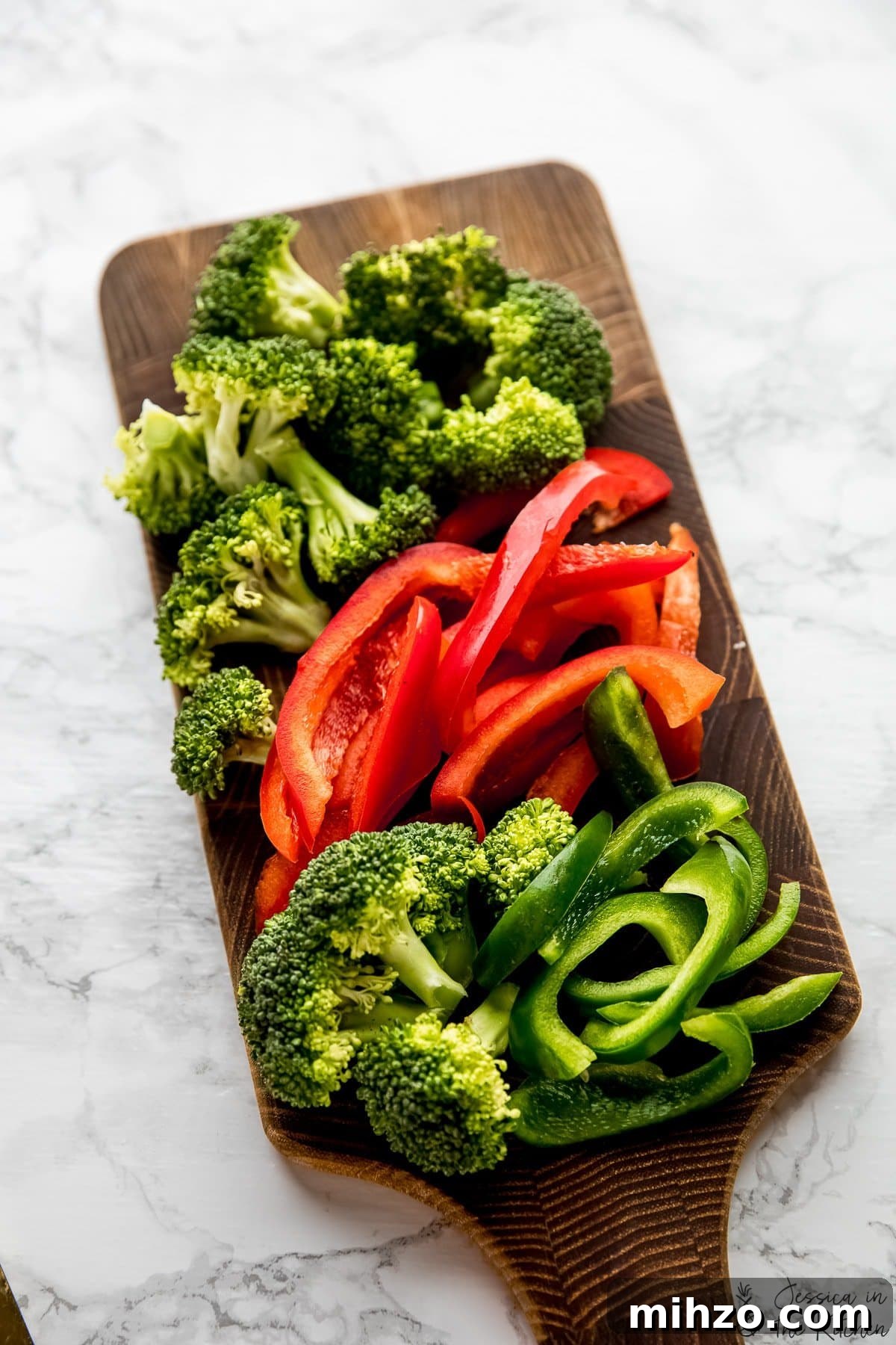 This fragrant Thai red curry is packed with veggies and tender marinated tofu for a satisfying meal. Just add rice or your favorite grain! chopped broccoli and bell peppers on a cutting board