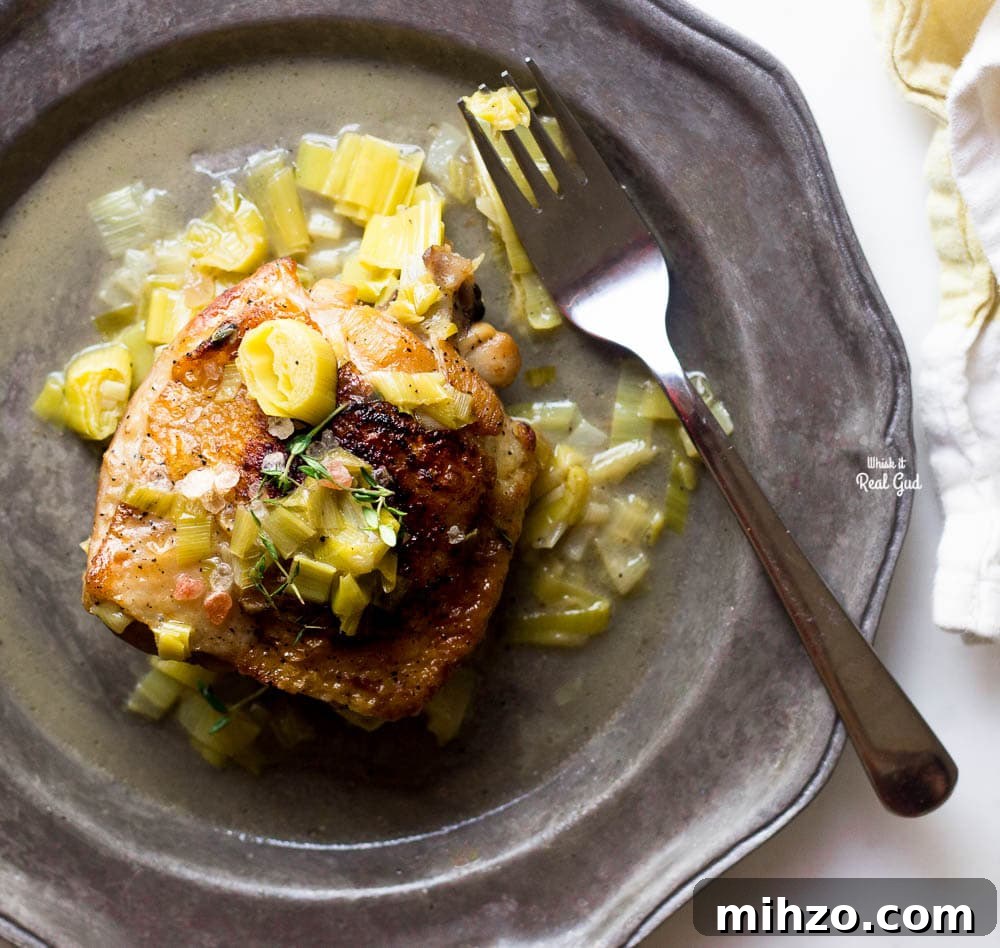 Cider-Braised Chicken with Apples and Thyme 5 braised cider chicken on plate with leek sauce