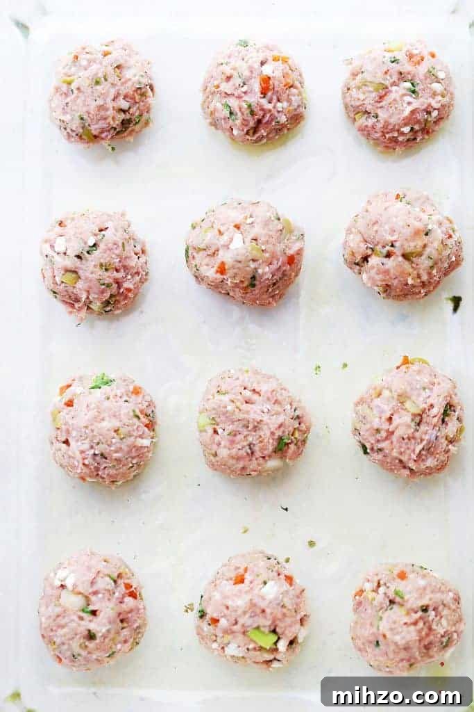Shape the meatballs. Shaped turkey meatballs on a white backdrop.