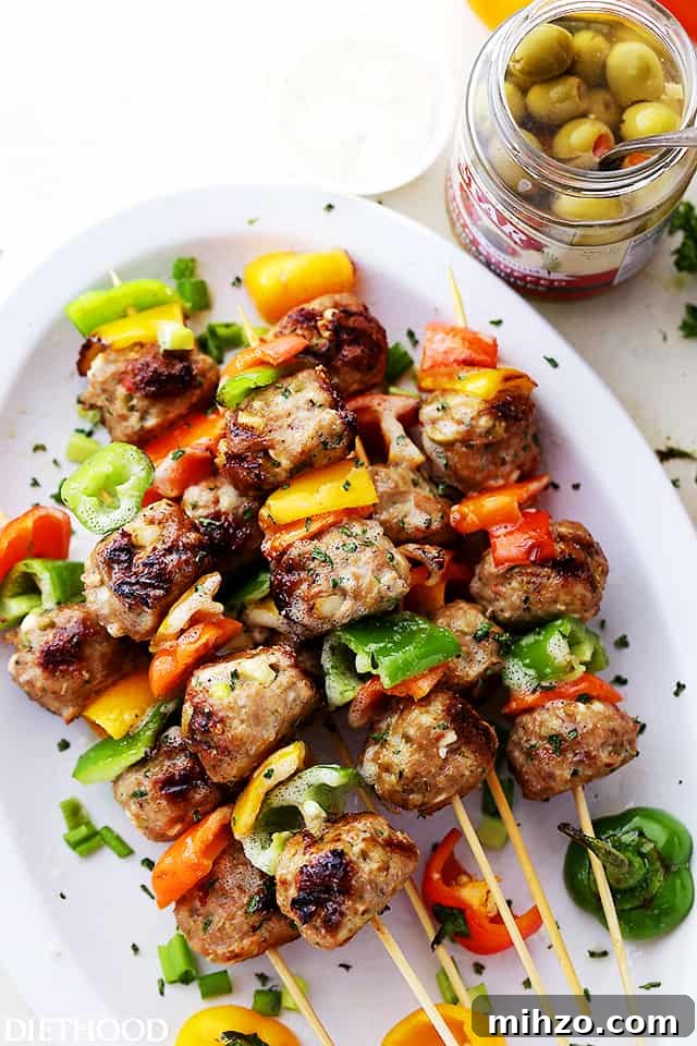 Grilled Turkey Meatball Skewers with Tangy Herb Sauce 4 Meatballs and bell pepper slices on skewers.