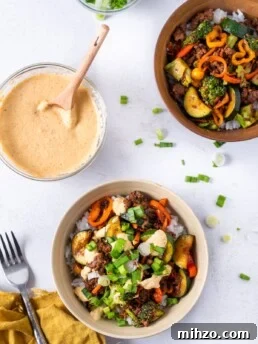 two bowls with teriyaki beef and veggies, small bowl of kimchi mayo