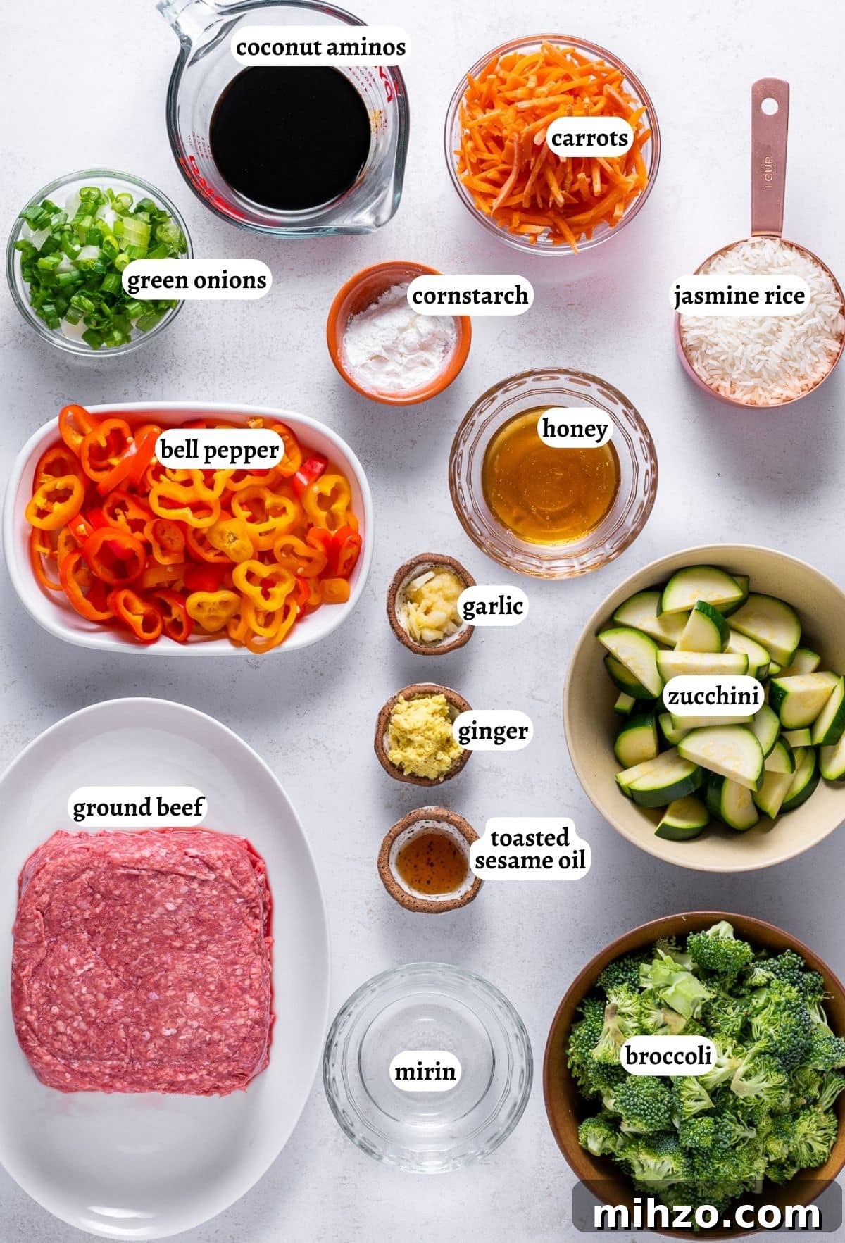 Teriyaki Beef Bowl with Spicy Kimchi Mayo Dressing 3 small bowls with the ingredients needed for the recipe: green onions, coconut aminos, julienned carrots, jasmine rice, cornstarch, honey, garlic, ginger, toasted sesame oil, zucchini, ground beef, bell pepper, broccoli, mirin