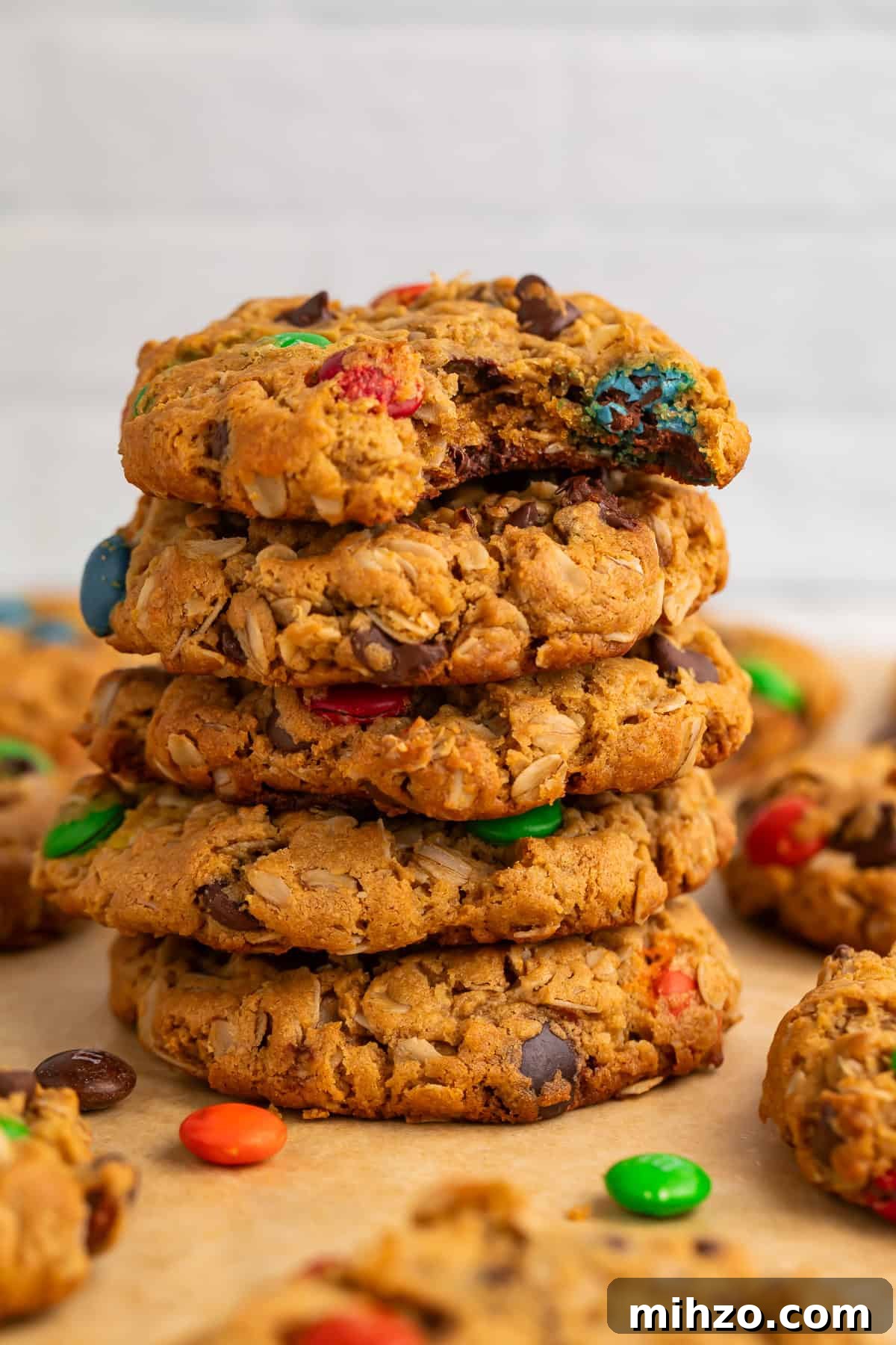 Gluten-Free Monster Cookie Recipe: Chewy, Chocolate-Packed Treats 3 Close up of a stack of monster cookies with a bite taken out of the top one.