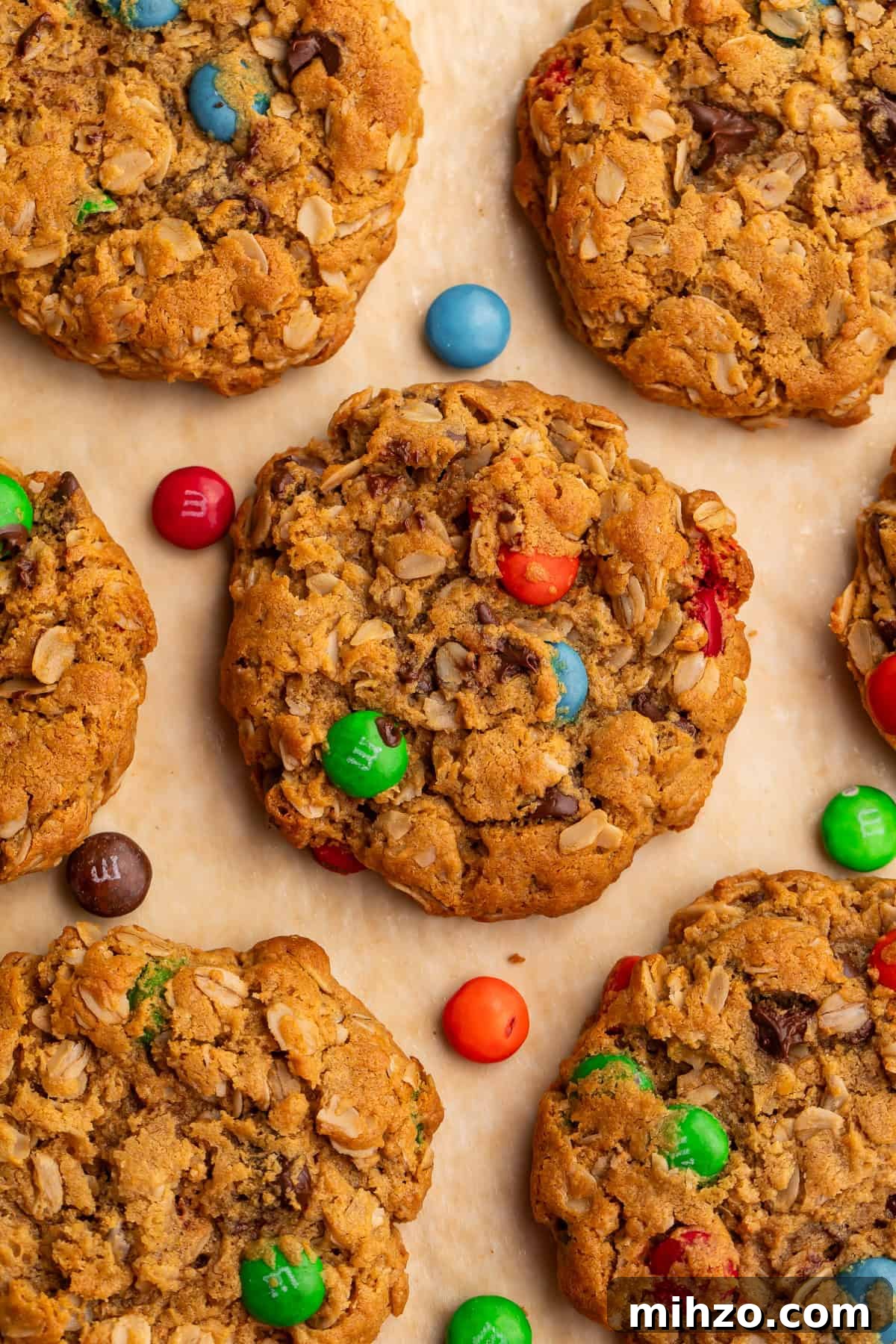 Gluten-Free Monster Cookie Recipe: Chewy, Chocolate-Packed Treats 4 Close up of a batch of monster cookies pictured overhead with M&M candies scattered around them.