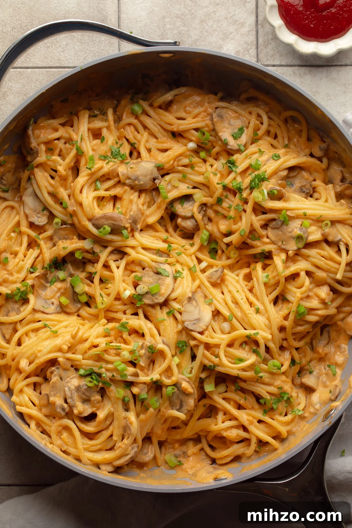 Creamy Gochujang Mushroom Noodles with Sesame and Scallions 2 overhead view of a skillet full of creamy gochujang noodles.