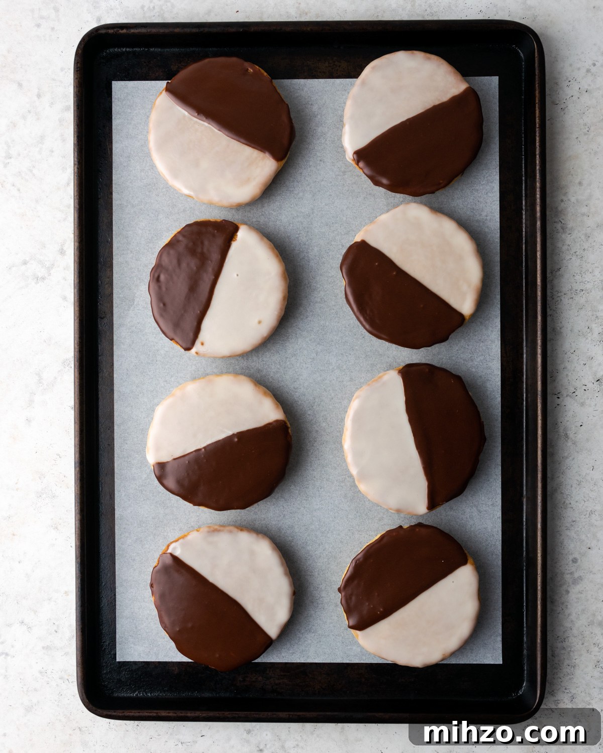 Gluten-Free Black and White Cookies Recipe: Classic New York Treat 4 Black and White cookies on a baking sheet.