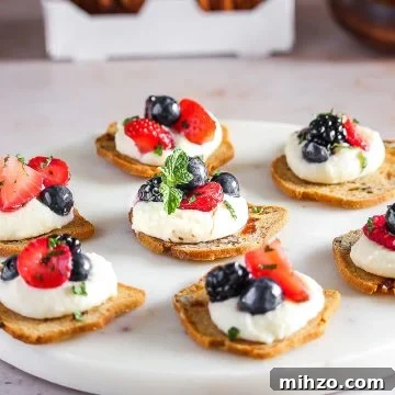 A slice of cracker crisps with mascarpone and berries