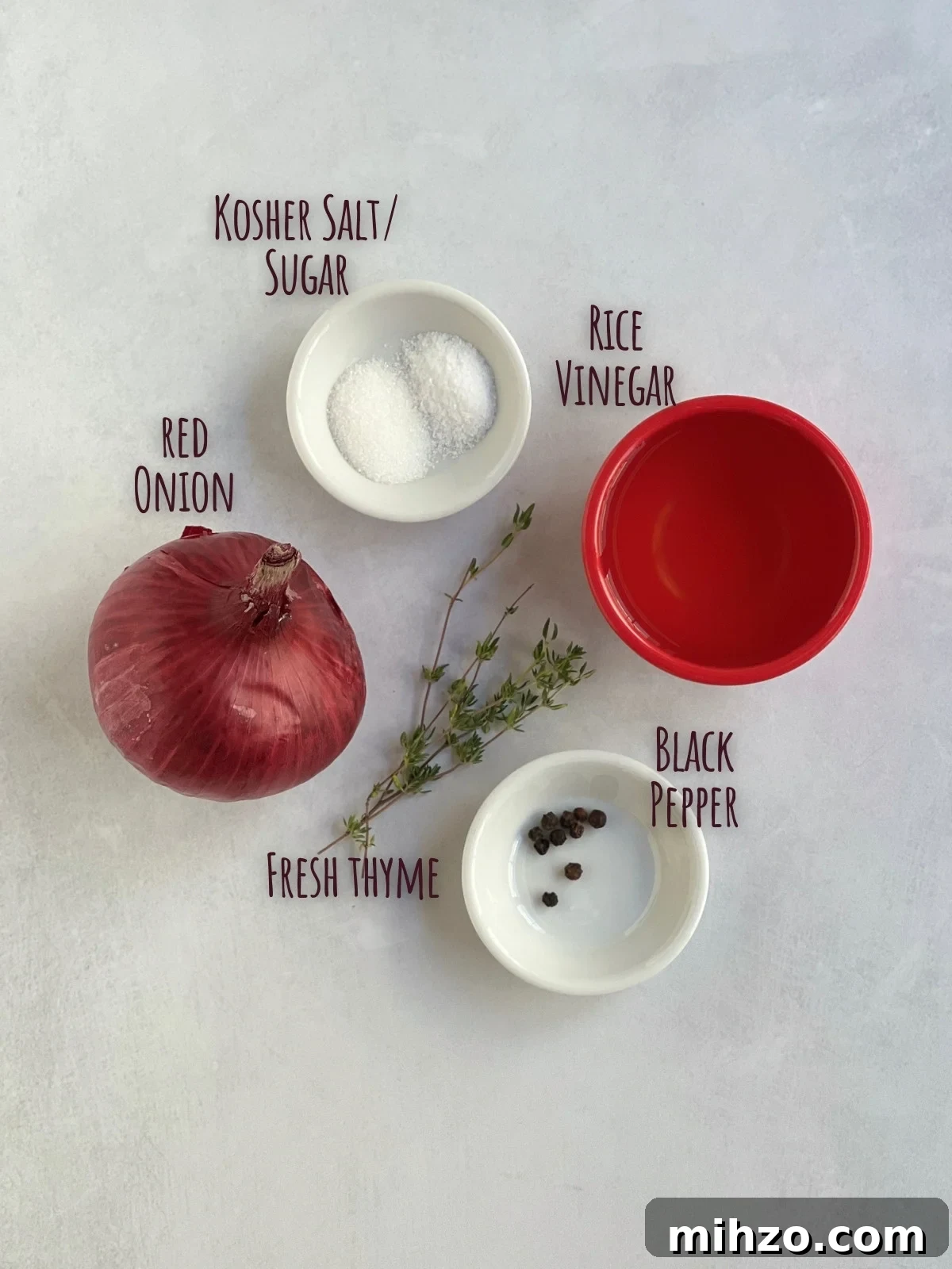 Crisp Pickled Red Onions: Quick Tangy Recipe for Sandwiches & Salads 3 Ingredients shot for pickled red onions showing a whole red onion, salt, sugar, rice vinegar and thyme and black peppercorns.