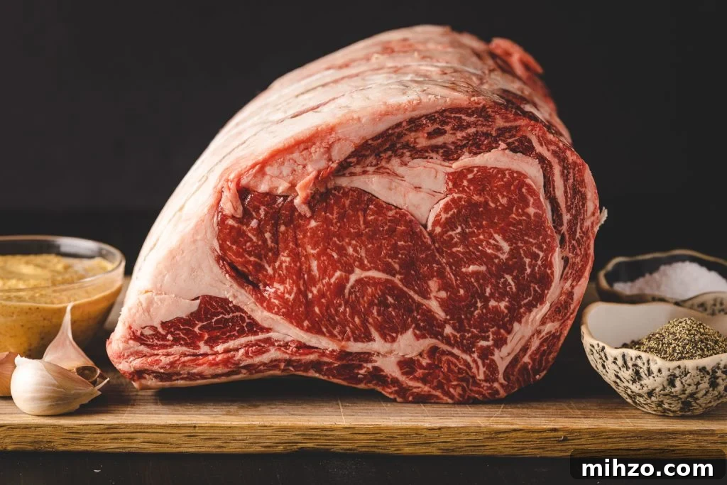 Smoked Prime Rib Roast Recipe for Tender, Juicy Results 3 Uncooked prime rib on a cutting board next to bowls of spices.