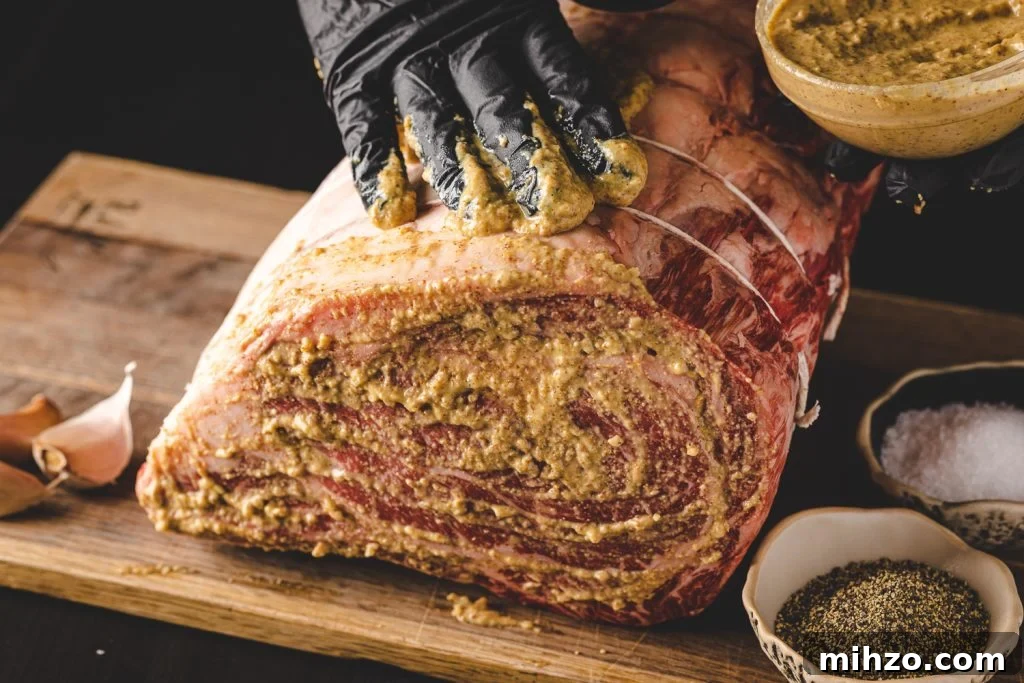 Smoked Prime Rib Roast Recipe for Tender, Juicy Results 4 Prime rib being slathered with a horseradish mustard sauce.