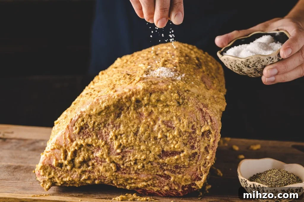 Smoked Prime Rib Roast Recipe for Tender, Juicy Results 5 Salt being sprinkled on a prime rib roast.