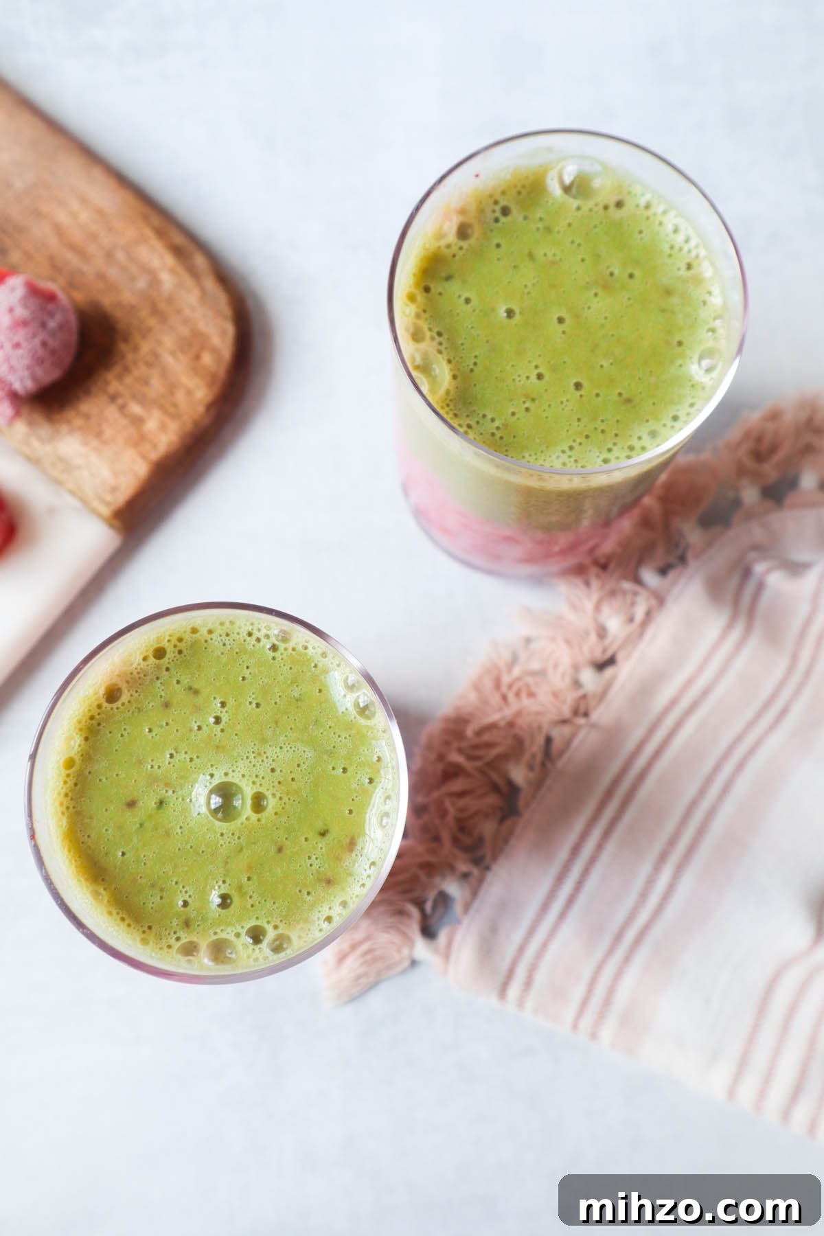 bird eye view of two glasses containing matcha strawberry smoothie