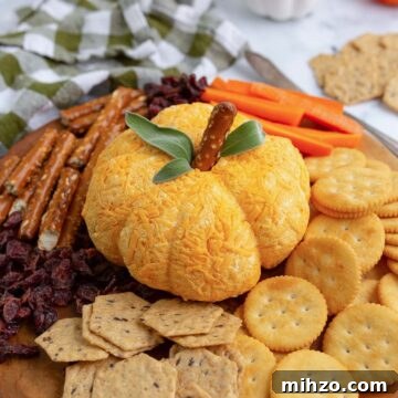 Pumpkin cheese ball apptizer dip shaped into a pumpkin.