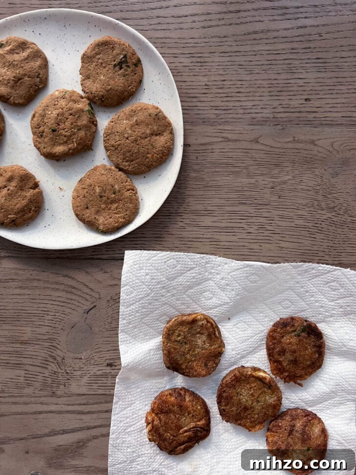 Pan-fried Shami Kabab on a paper-towel lined plate along with Shami that are ready to freeze