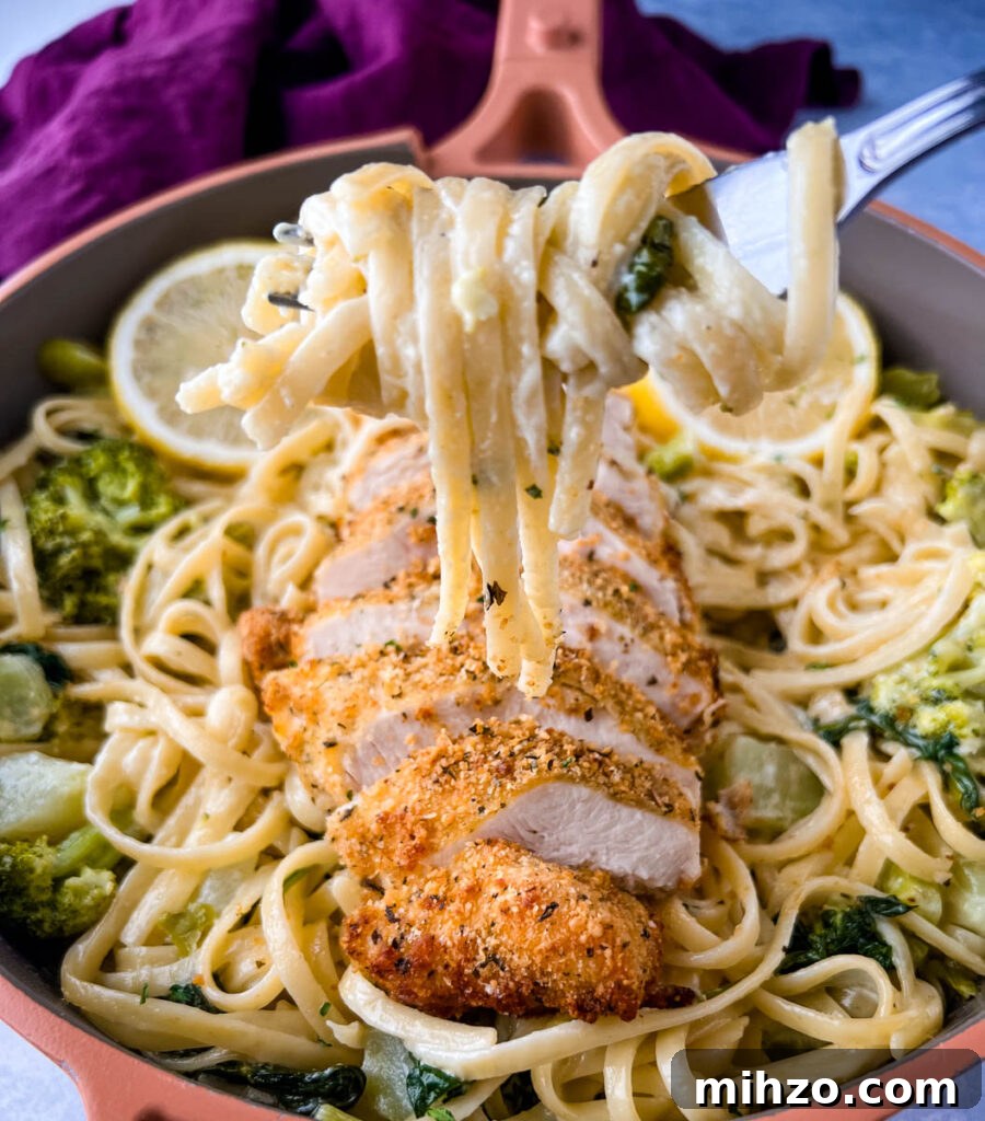 Lemon Garlic Chicken Pasta with Creamy Parmesan Sauce 15 a fork filled with lemon pasta