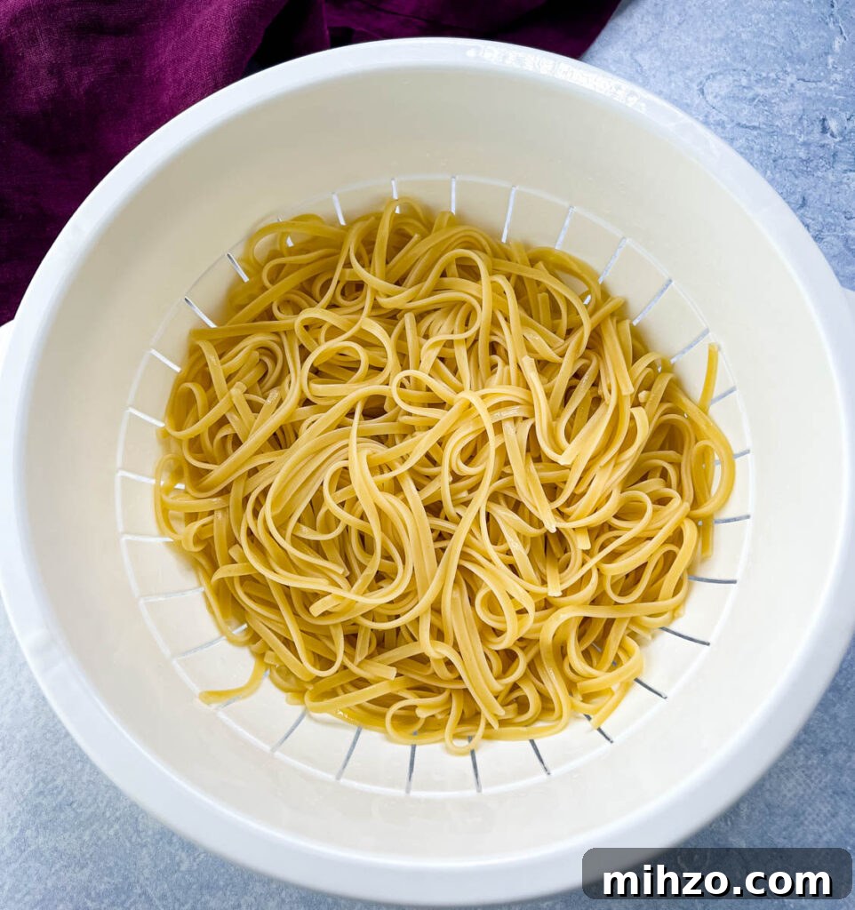 Lemon Garlic Chicken Pasta with Creamy Parmesan Sauce 4 cooked fettuccine in a colander