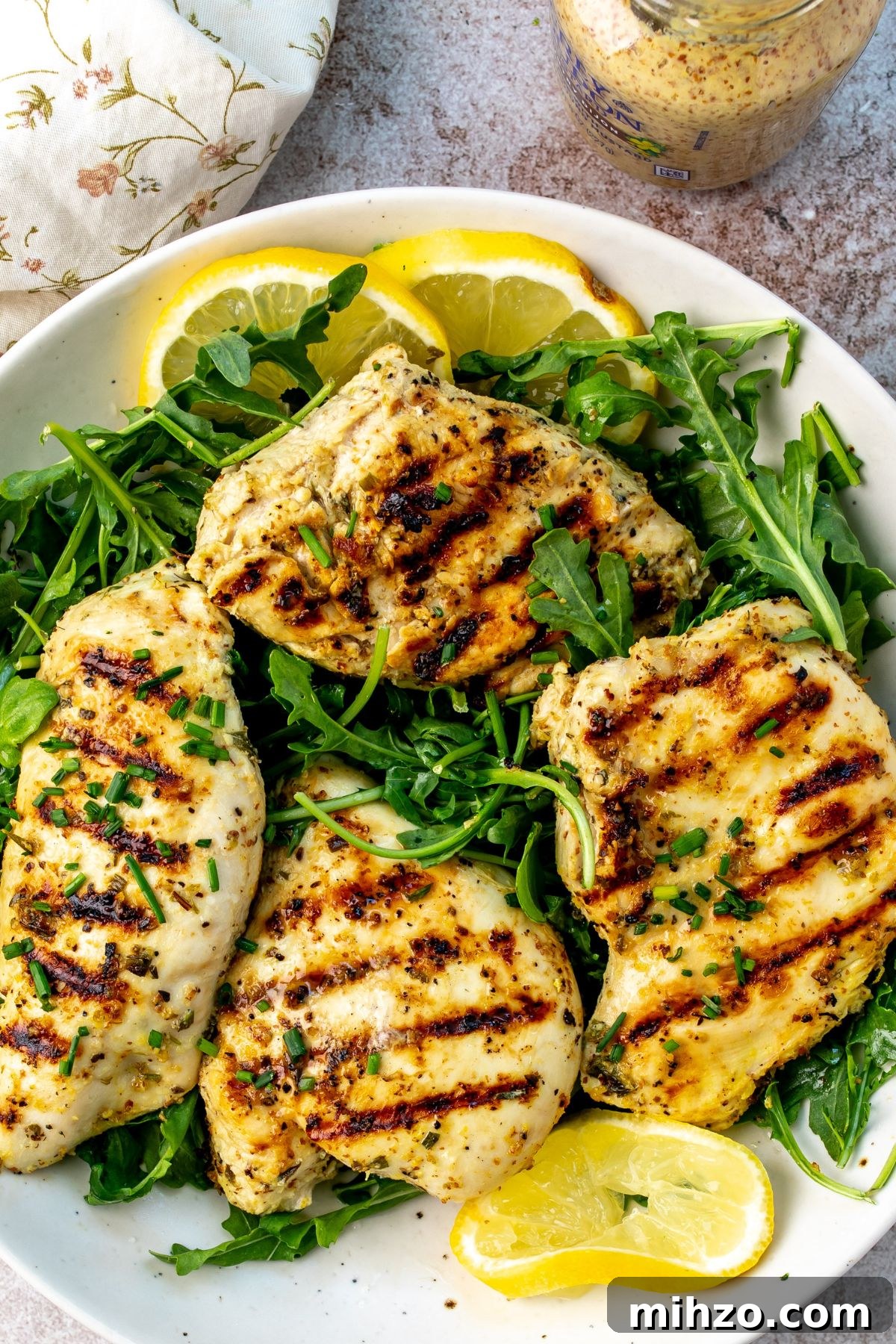 Herb Lemon Chicken on a plate with lemons.