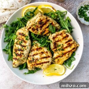 Herb Lemon Chicken on a plate with lemons.