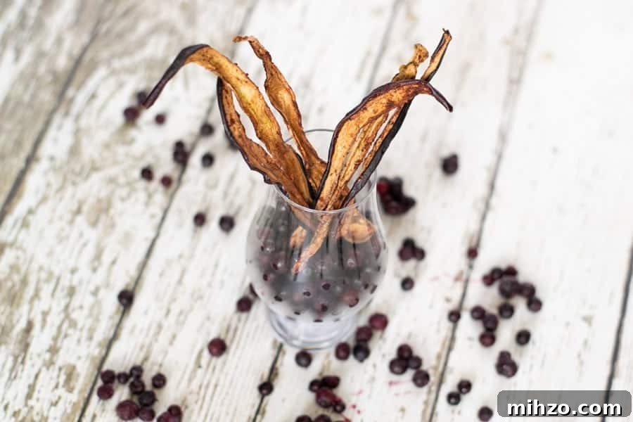 blueberries on white wood table, eggplant jerky in glass jar filled with blueberries