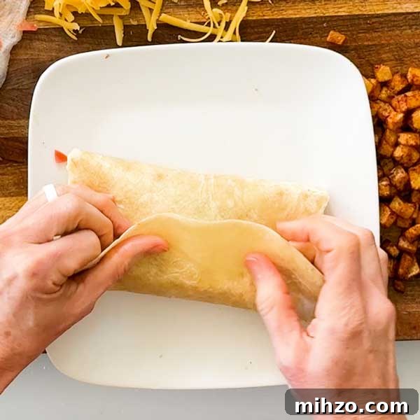 High-Protein Breakfast Burrito with Crispy Potato Filling 11 Folding the last tortilla flap over the burrito.